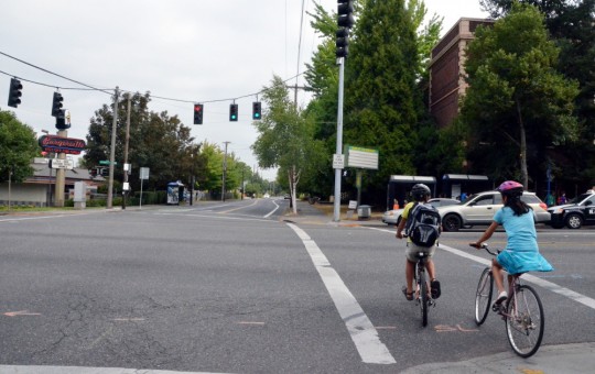 students biking in crosswalk 26th powell