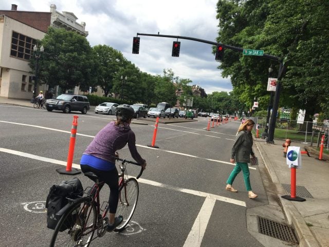 The cones and wide bike lane are temporary, the legal requirement to stop at lights is not.(Photo: J. Maus/BikePortland)