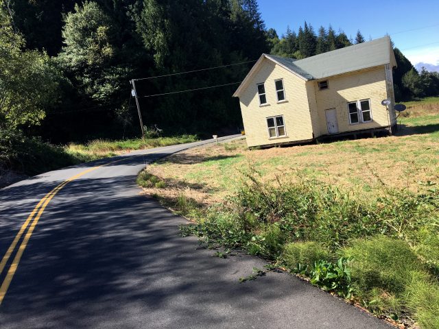 This old house is precariously close to the road.