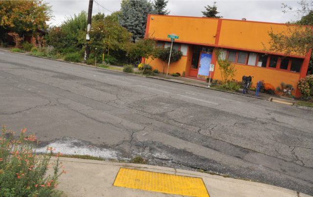 Looking north at the preschool (orange building). The crosswalk used to be on the right.