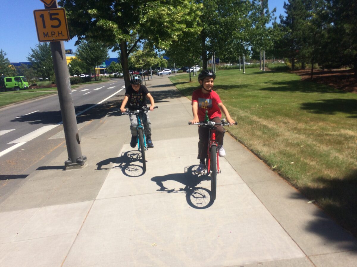 Riding bicycle on sale on sidewalk