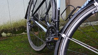 dirty bike on mossy pavement and dirty garage backdrop