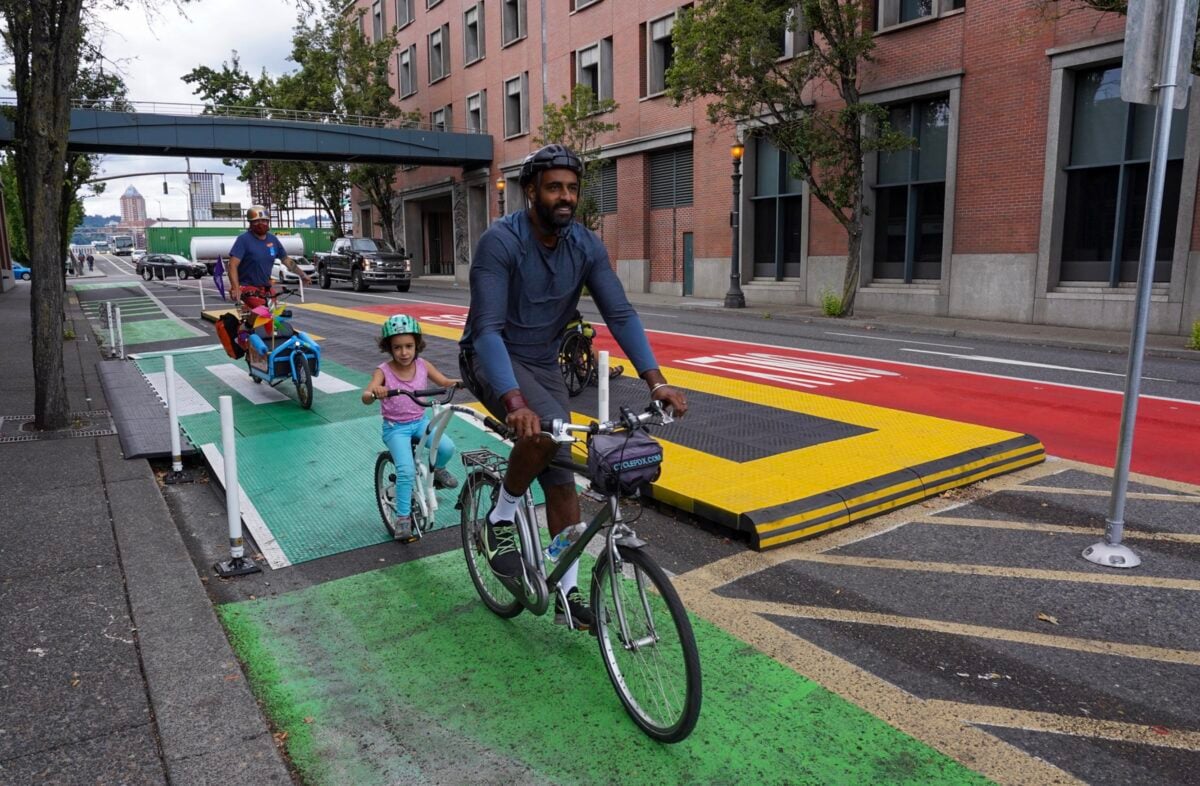 Bike riders roll through a bus platform on Hawthorne Blvd