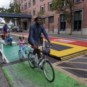 Bike riders roll through a bus platform on Hawthorne Blvd