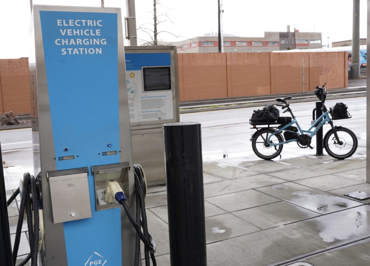 EV charging station with a bicycle in the background.