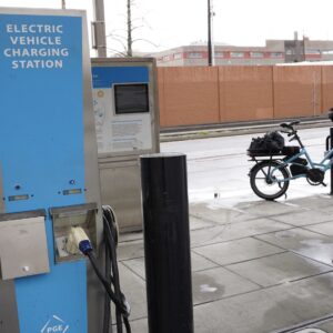 EV charging station with a bicycle in the background.