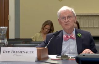 Congressman Earl Blumenauer at a hearing speaking into a mic.