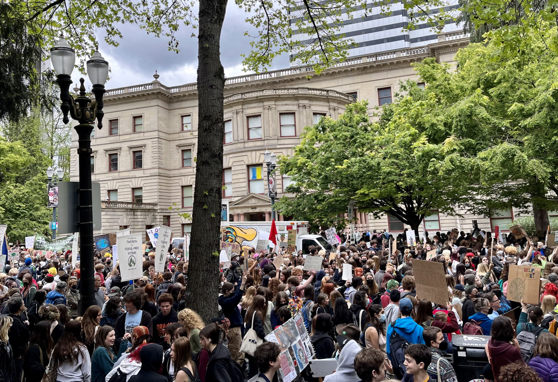 Large crowd of people outside Portland City Hall building.