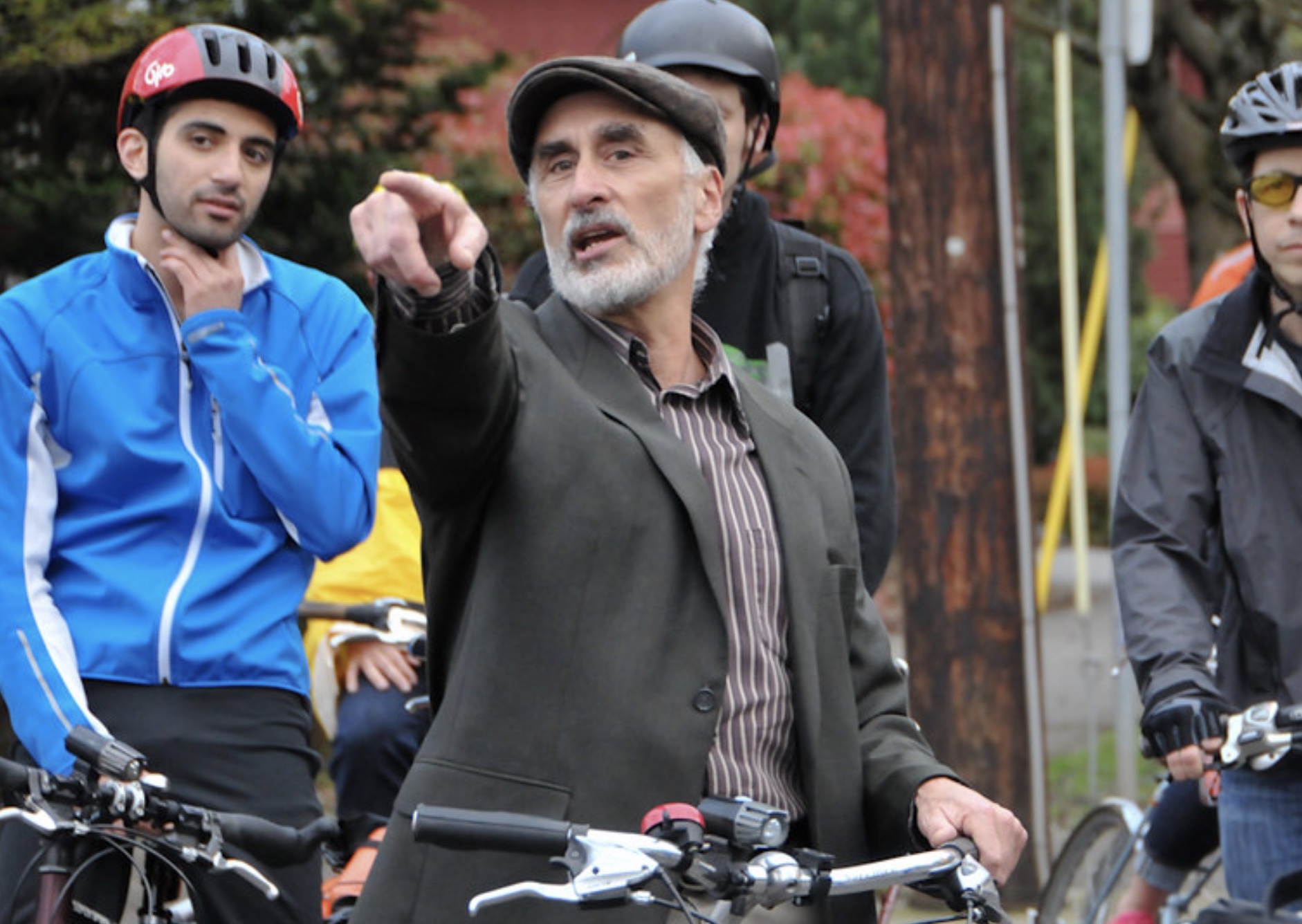 Man on a bike pointing