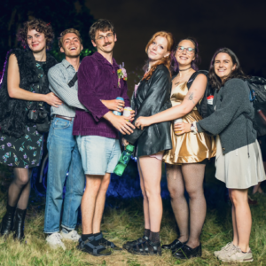 Six people posing together in prom style shot.