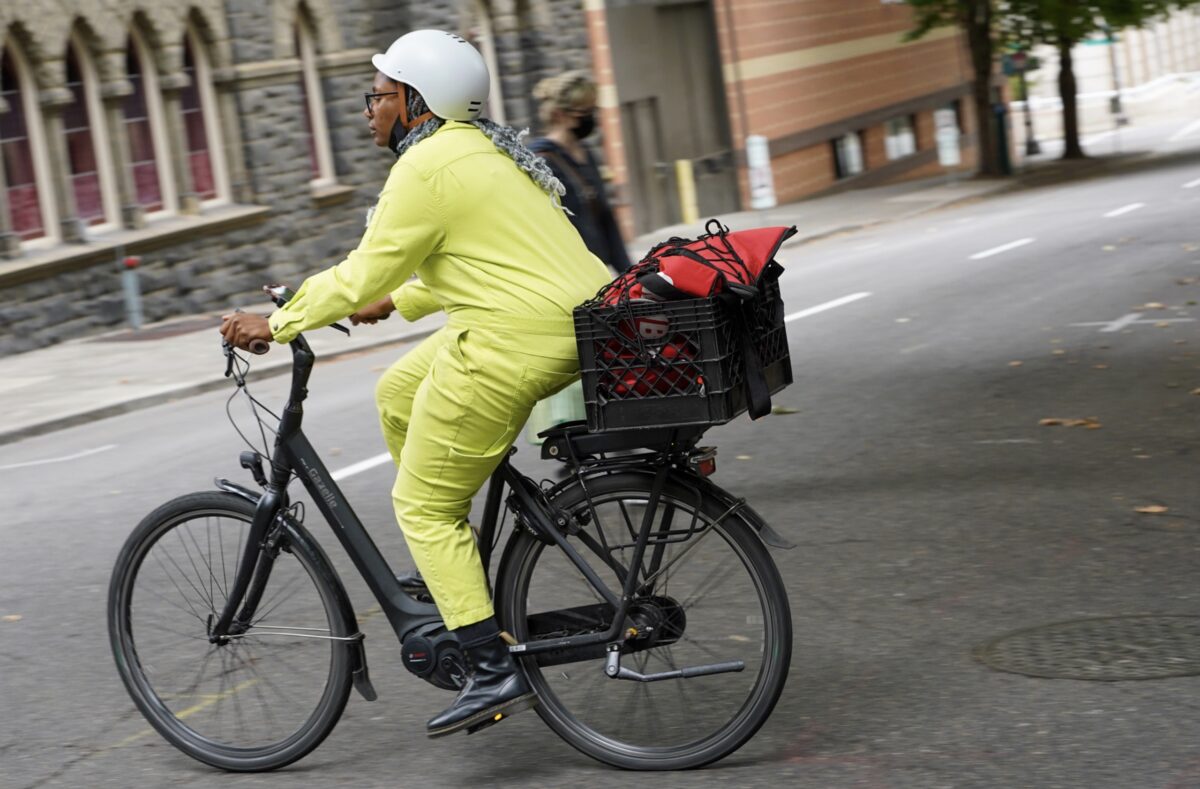 Person in yellow suit biking.