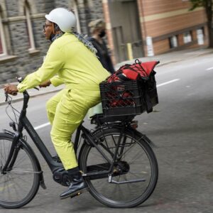 Person in yellow suit biking.