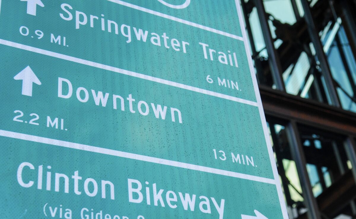 traffic sign with destinations and biking distance