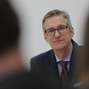 portland mayor ted wheeler looking into the camera at a meeting