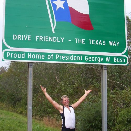 Dad-at-Welcome-to-Texas-Sign-Riding-Cross-Country-2006-edited